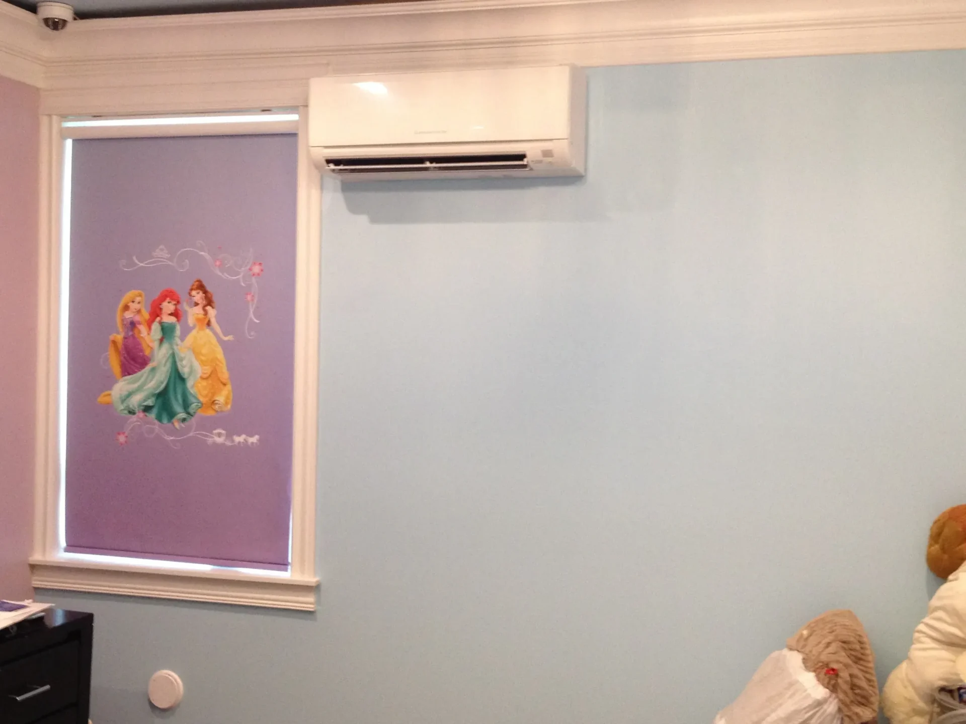 Air conditioner above colorful window shade